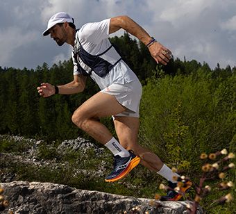 A person jumping up a hill.