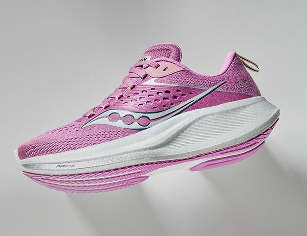 A pink and white Saucony Ride running shoe.