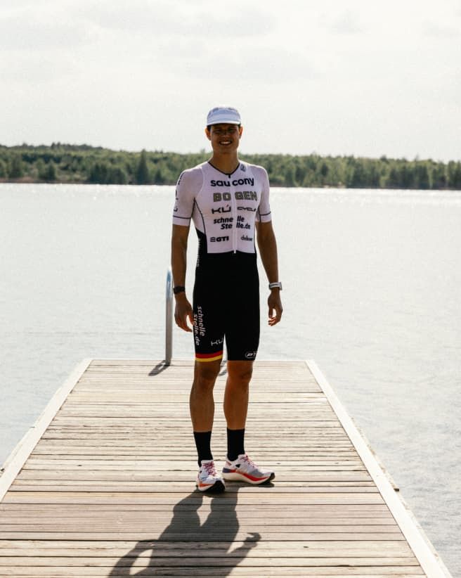 Rico standing near the water after a race.