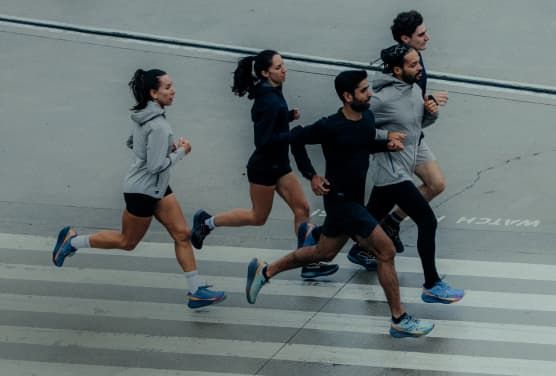 a group of people running on a street