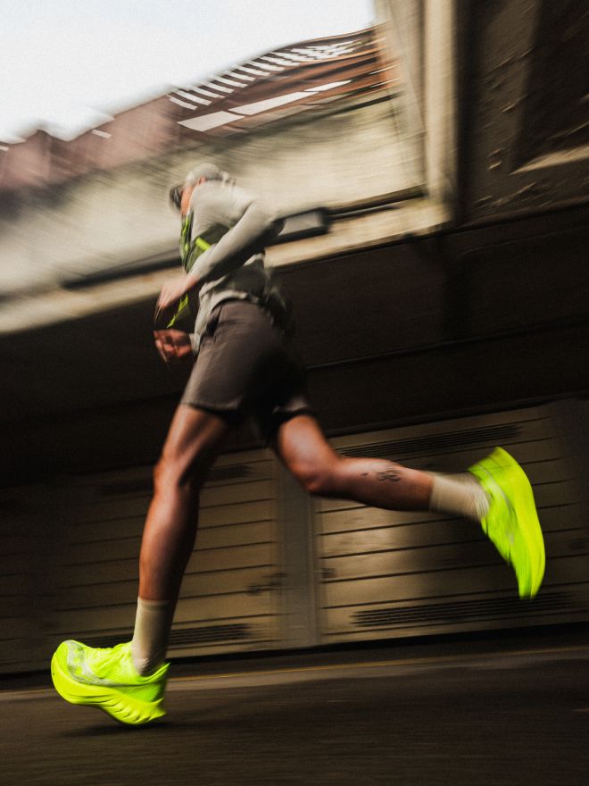 a person running with yellow shoes