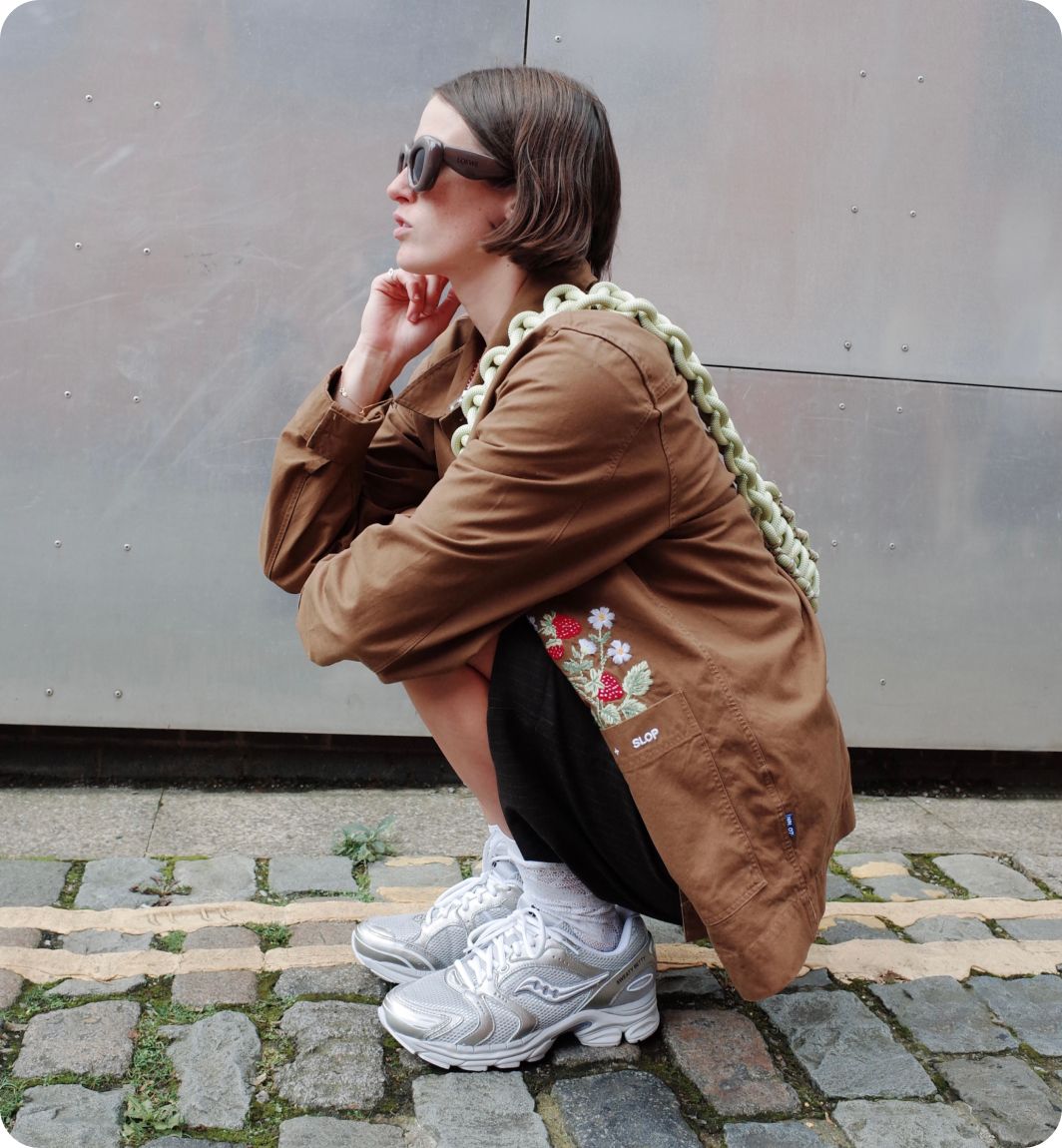 a woman squatting on a brick surface