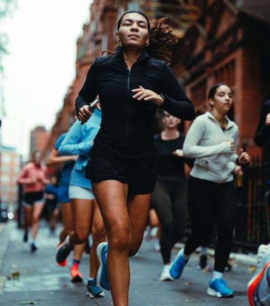 a group of people running on a street