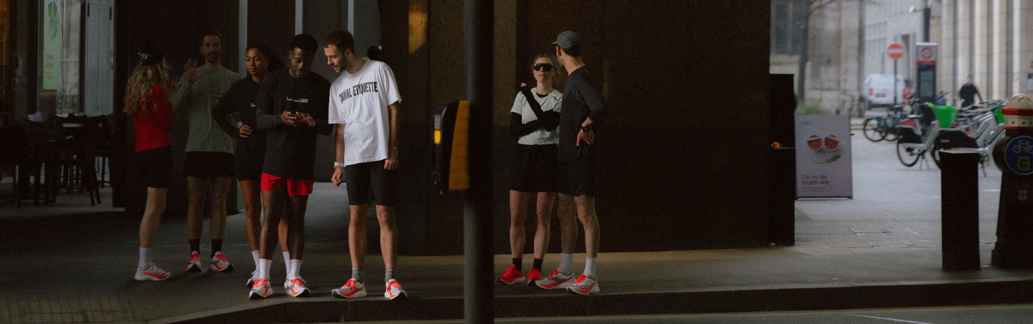 a group of people standing on a sidewalk