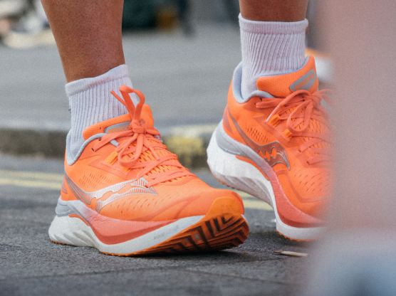 a person's feet wearing orange shoes
