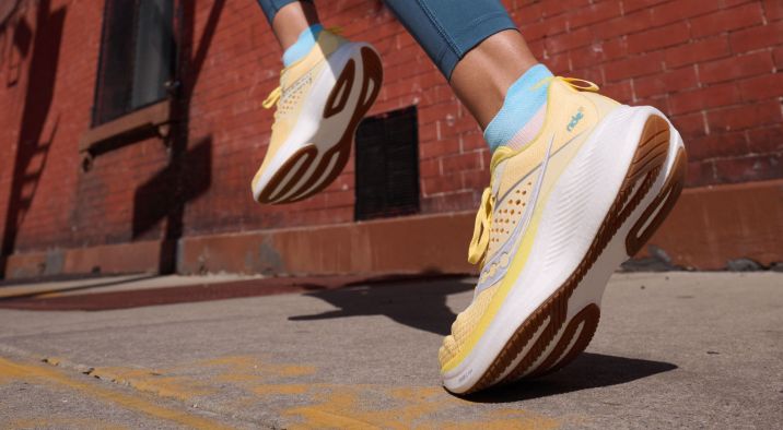 a person's feet in yellow and white shoes