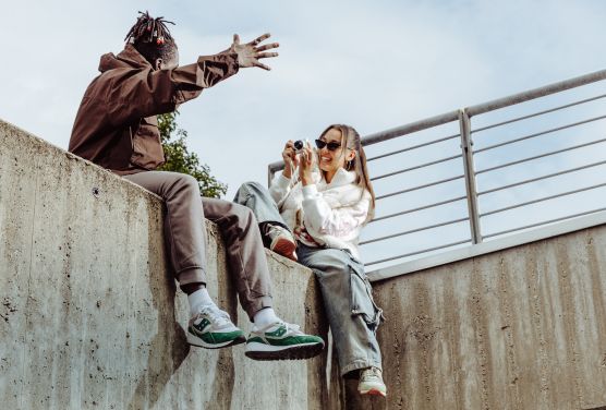 a man and woman sitting on a ledge