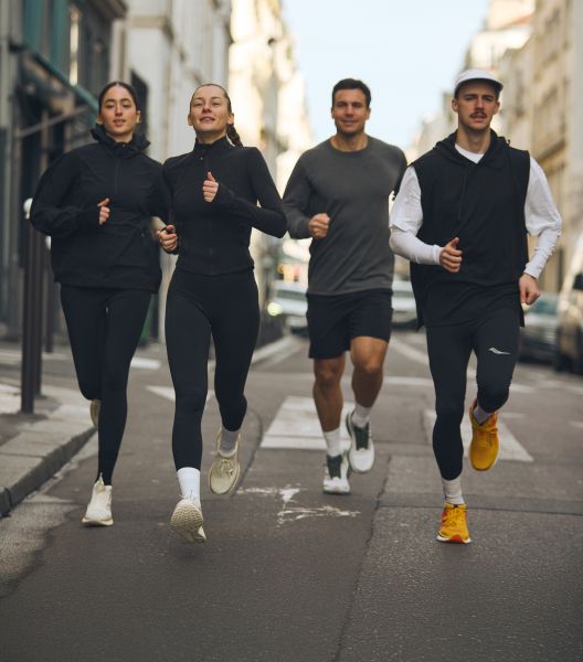 a group of people running on a street